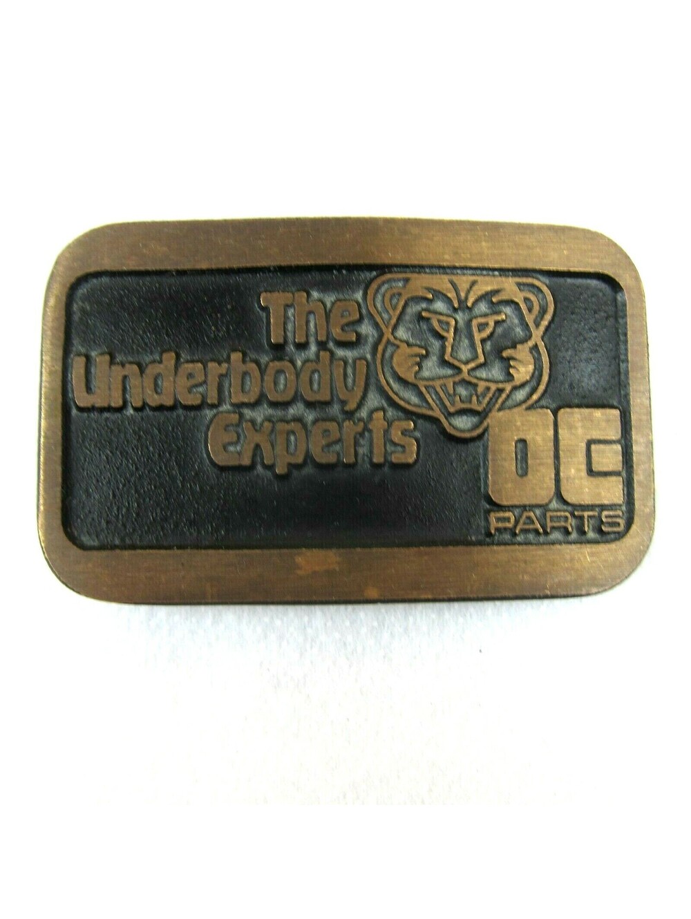 Vintage DE Parts Underbody Experts Belt Buckle Brass Car Mechanic Advertise USA